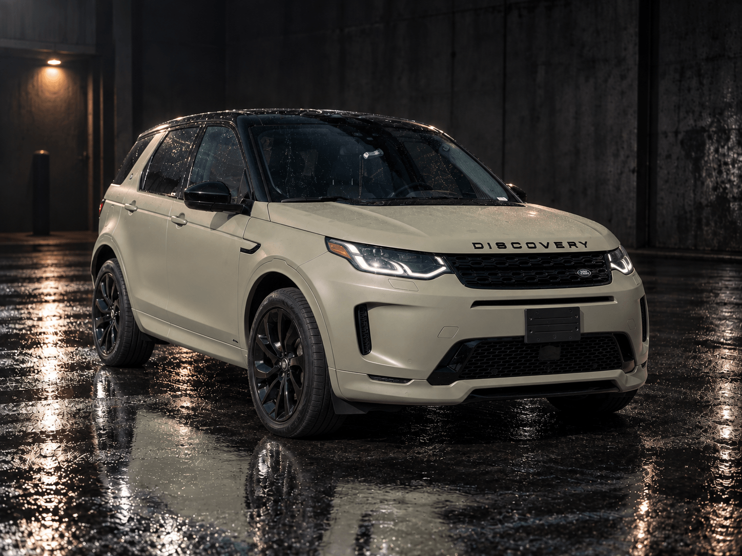 Land Rover Discovery wrapped in satin desert tan vinyl with black roof and wheels